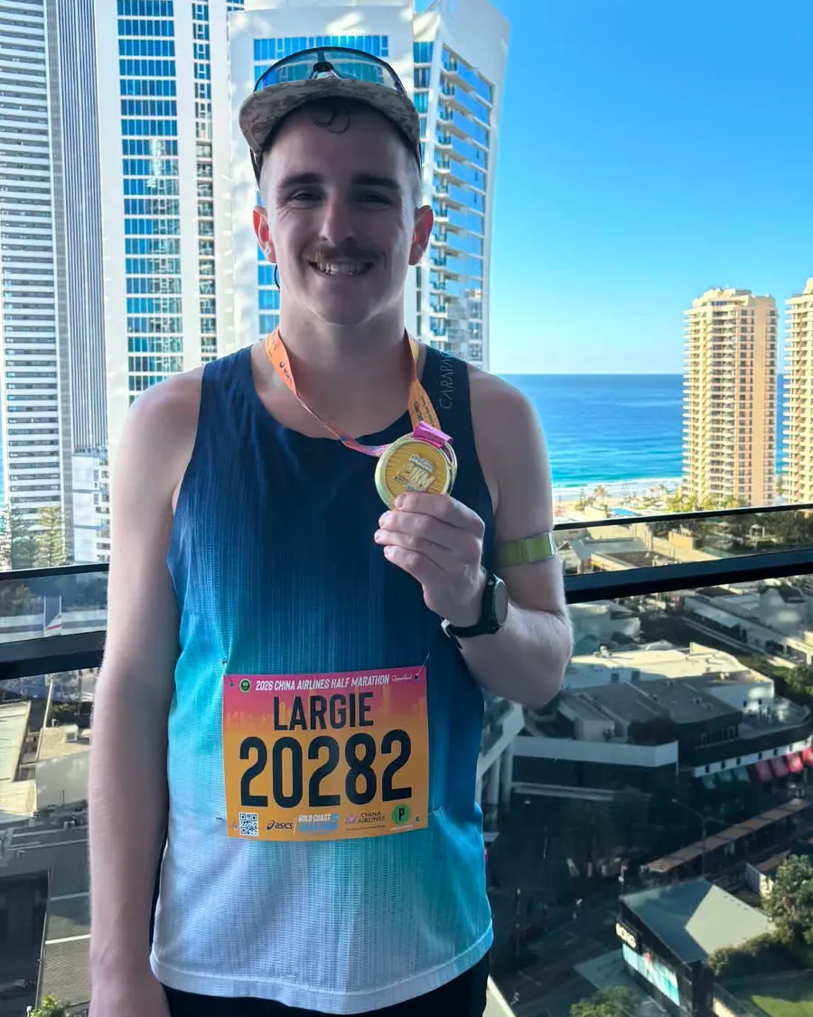 Josh Hudson with his medal after the Gold Coast half marathon